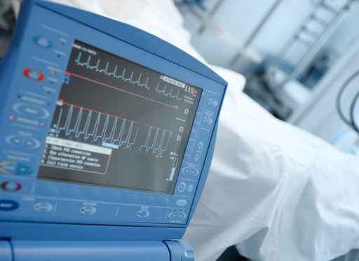 Modern ICU monitor in clinical ward next to the bed of the patie