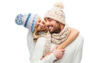 smiling couple in winter clothes hugging
