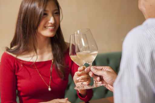 Men and women who have a toast with white wine
