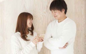 Young couple laughing happily face to face