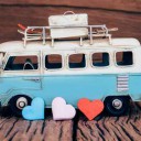 Hearts with blue van background on old wooden table.