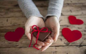 Women have a chocolate with a red ribbon